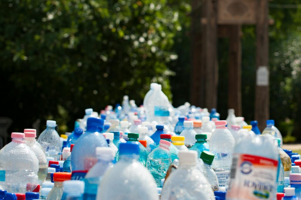 pexels photo 802221 802221 A vibrant collection of plastic bottles in an outdoor recycling setup, showcasing environmental awareness.